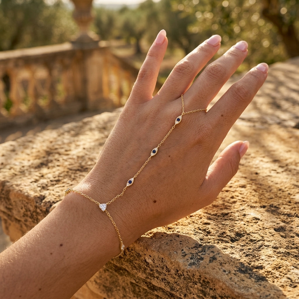 Blue evil eye hand chain bracelet with zircon accents