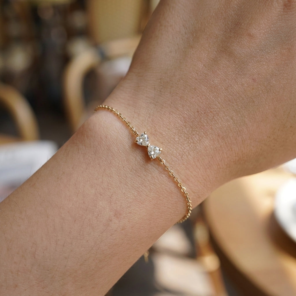 Delicate gold bracelet with bow and zircon stones