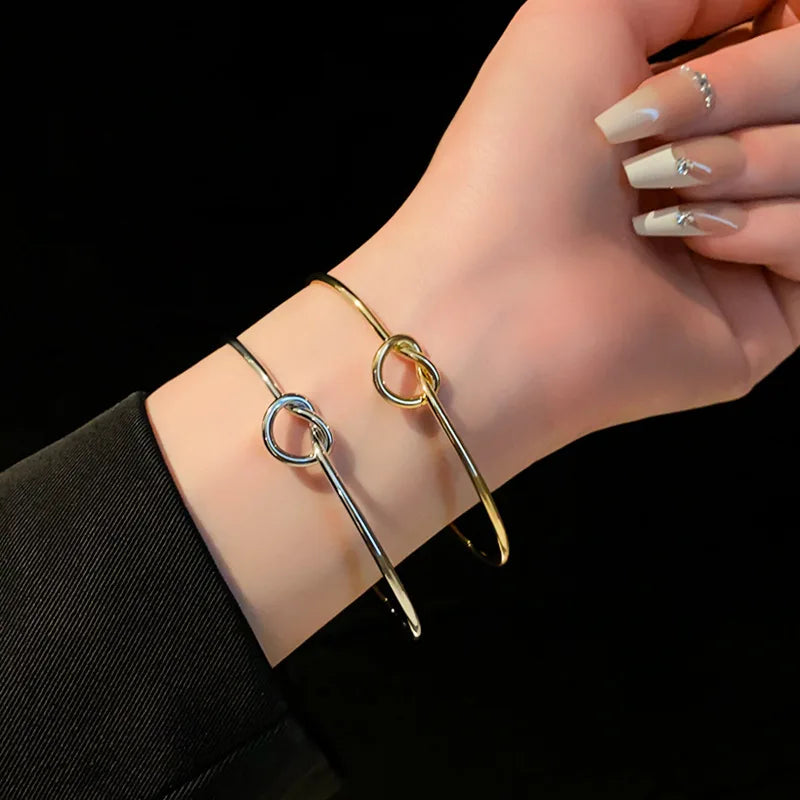 Model wearing a women's gold twist cuff bracelet for an elegant look