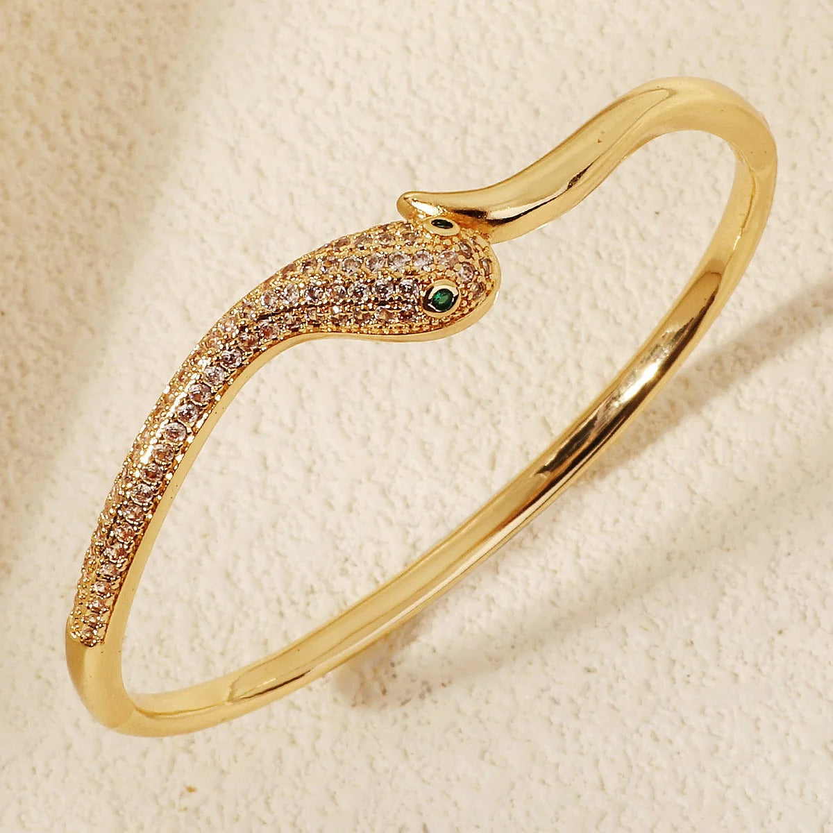 Gold Snake Wrap Bracelet with Cubic Zirconia crystals on white background