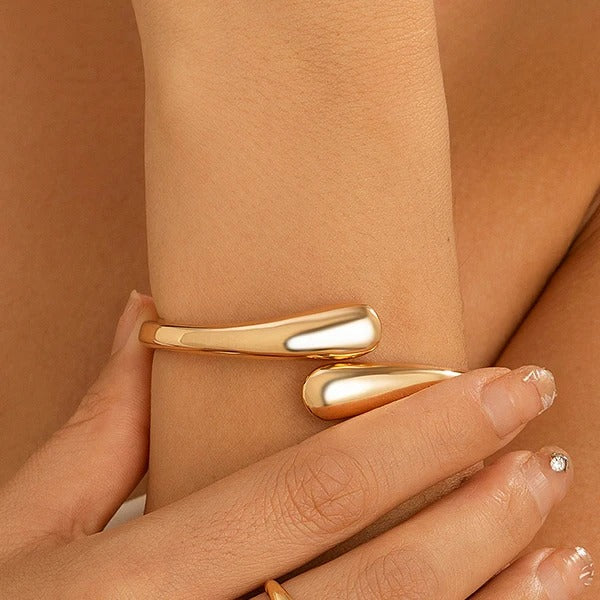 Sleek gold cuff bangle from the Velmeera women's jewelry collection