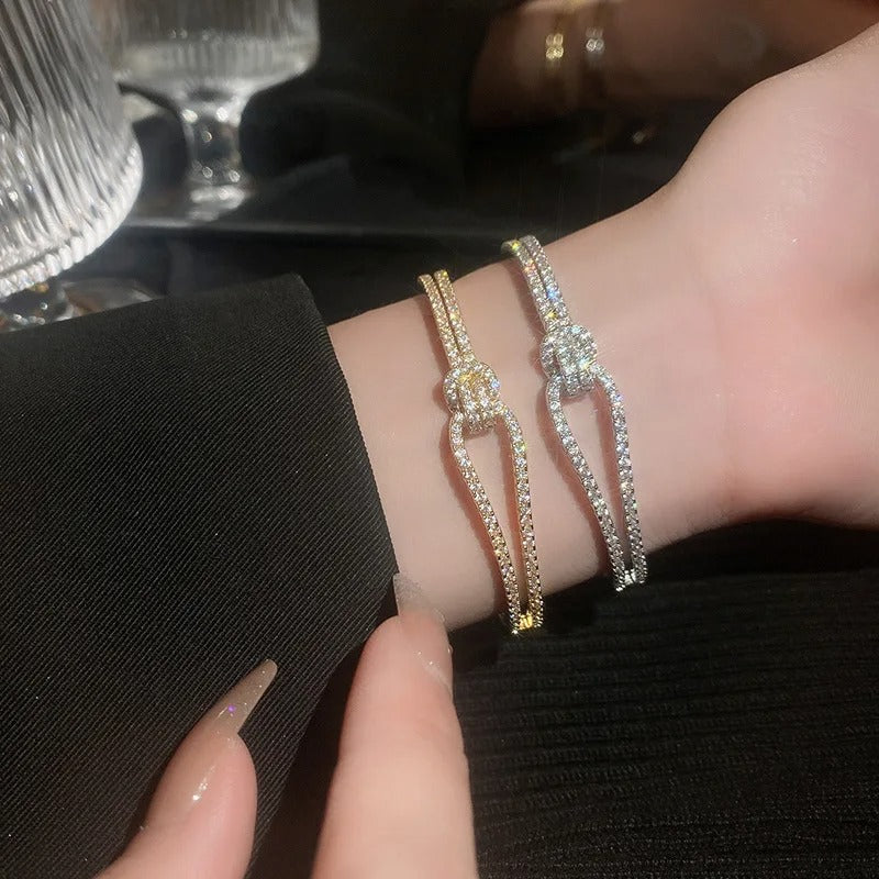 Model wearing a stackable knot cuff bracelet for a modern jewelry look