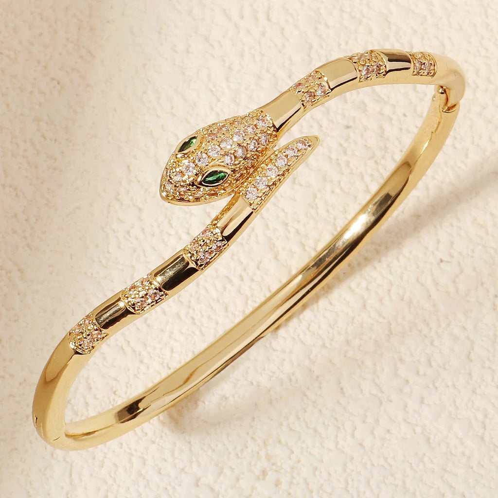 Snake wrap bracelet paired with gold rings for a luxury aesthetic