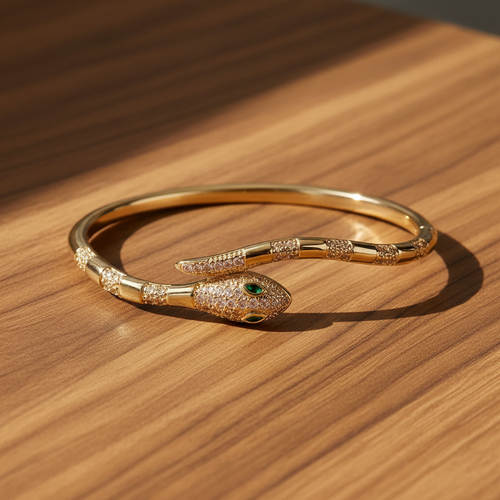 Close-up of the serpent head detail on a wrap-around gold bangle